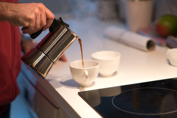 Fototapeta na wymiar Pouring coffee from a moka pot