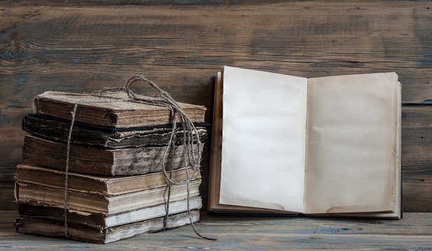 Old books on wooden planks background