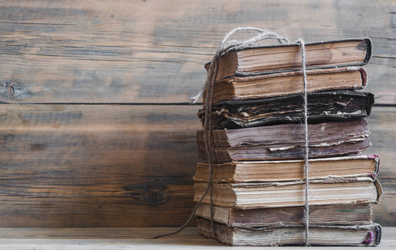 Old books on wooden planks background