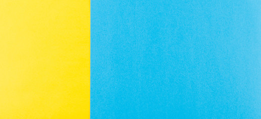 Abstract geometric yellow and blue paper background.