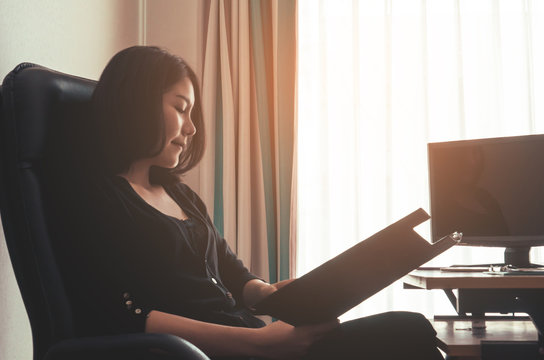 Business Woman Is Reading Business Report With Happy Relax Emotion