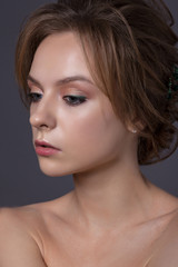 Obraz premium Portrait of a beautiful teenage girl on a gray background.