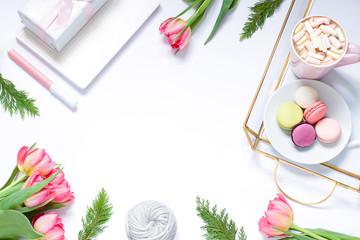 Flat lay composition with fresh flowers, tray, coffee and macaroons. Lifestyle concept frame. Top view. Copy space