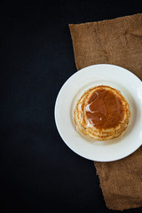 appetizing pancakes with honey on a dark table. Menu , restaurant recipe concept. Served in. Top view
