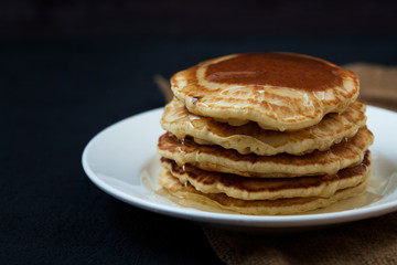 appetizing pancakes with honey on a dark table. Menu , restaurant recipe concept. Served in.
