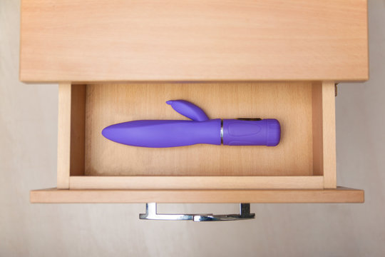 Sex toy in open countering bedside table