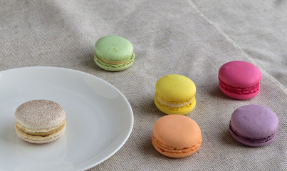Tasty french assortment of  macaroons on cloth with vintage color tone, a French sweet meringue-based cookies