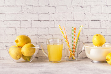 Lemons and juicer for making lemon juice.