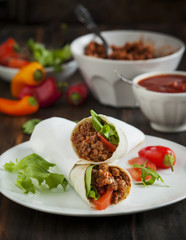 Burritos filled with meat and vegetables