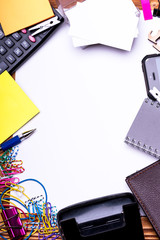 Business cards and binders near sticky notes and puncher.