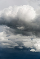 Obraz premium Gray and white storm clouds on a dark blue sky