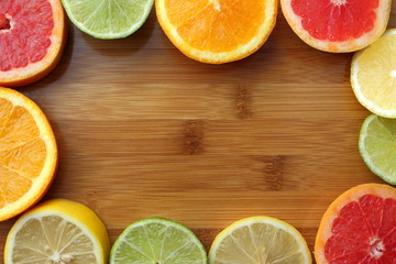 Mix of sliced colorful citrus fruits in foursquare top view. Orange, lemon, grapefruit and lime...