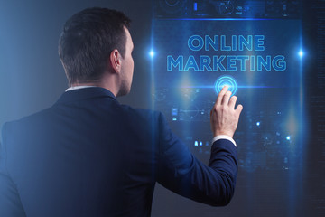 Business, Technology, Internet and network concept. Young businessman working on a virtual screen of the future and sees the inscription: Online marketing