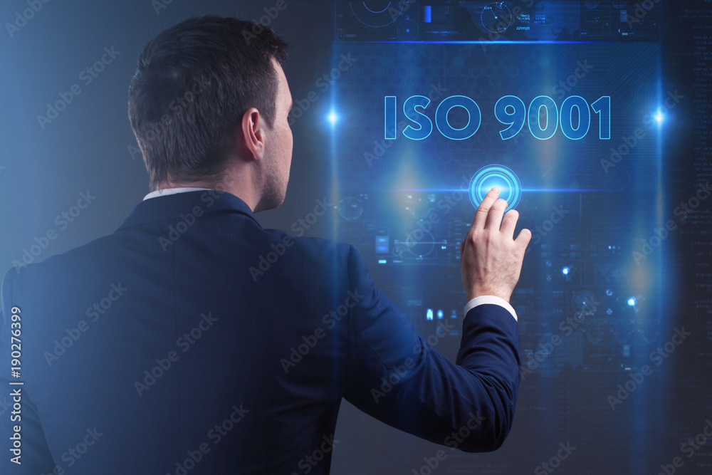 Wall mural Business, Technology, Internet and network concept. Young businessman working on a virtual screen of the future and sees the inscription: ISO 9001