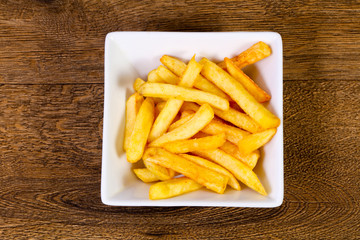 French potato over wooden background