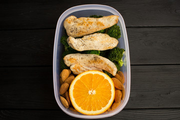 Lunch witn chicken  in the box on the black wooden background