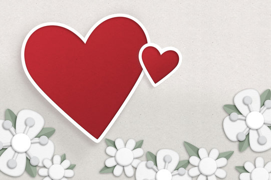 Hearts and flowers. Paper cut style illustration with two hearts and some white flowers.