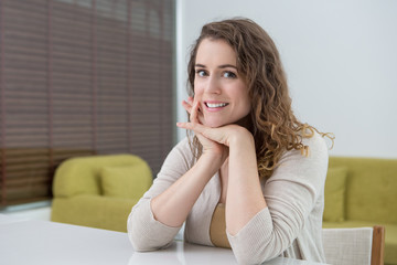 Fototapeta premium Smiling Attractive Woman at Table in Living Room