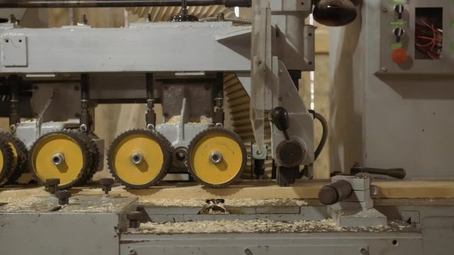 Running spiked wheels of plank refiner machine working on wood at sawmill production, close up