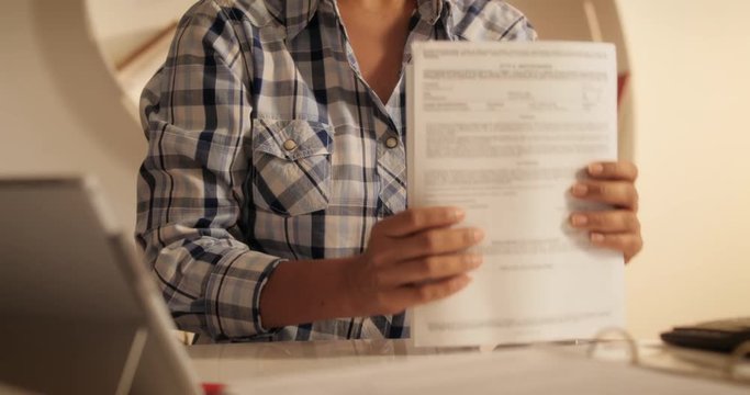 Old Hispanic Woman Filing Forms For Tax Return At Home
