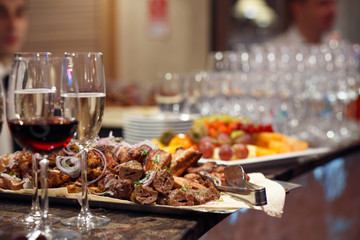 shish kebab with red onion and glasses of champagne