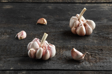 Garlic, Garlic cloves and Garlic bulb in vintage handmade wooden dark table.