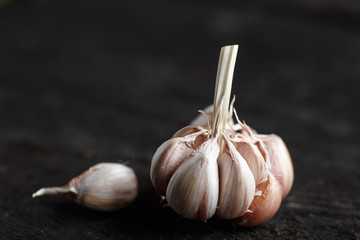 Garlic, Garlic cloves and Garlic bulb in vintage handmade wooden dark table.