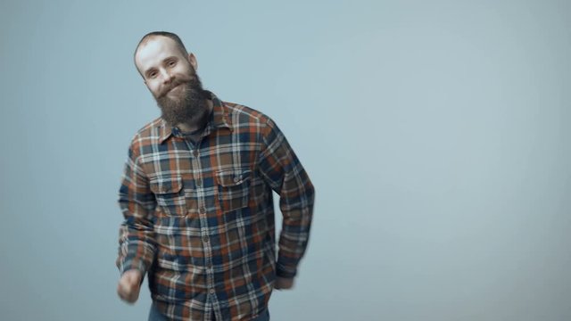Satisfied bearded man dancing joyfully