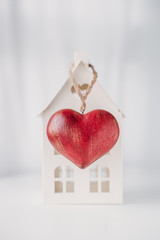 Home and red heart on white background.  concept for St. Valentine's Day and sale of houses