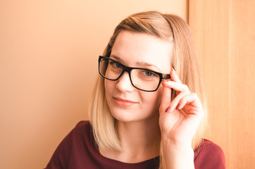 Portrait of a happy smiling young woman in glasses