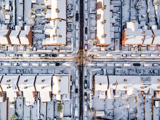 Aerial view of snow covered traditional housing suburbs in England. Snow, ice and adverse weather...