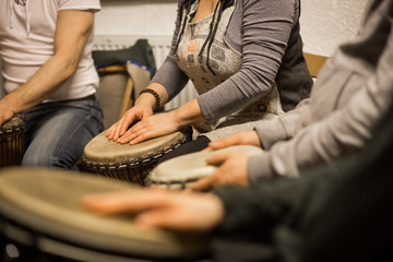 Close up of hands on african drums, drumming for a music therapy