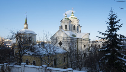Pokrovskaya church in Kiev on the Podol. Built in 1772 by the architect IG Grigorovich-Barsky. Winter sunny day. Ancient orthodox church with green domes