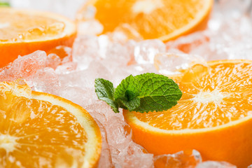 Fototapeta na wymiar Orange slices in ice, macro.