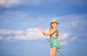 slender young blonde girl fishing on boat