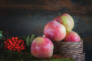 Harvest of apples in the basket prepared for cooking in the fall on the table. Village.