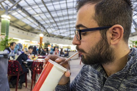 Man drinking a beverage in a cafe