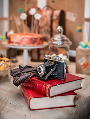 old vintage camera with old books on table