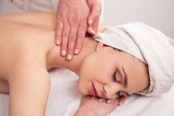 Obraz na płótnie Canvas Woman is having a massage in salon