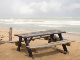 Wooden table on the beach, ocean