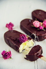 Popsicle - ice cream on a stick covered with chocolate icing, ice cream with the floral taste of the rose