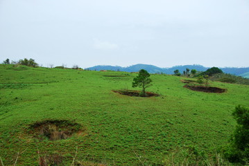 Bomb craters from the Vietnam War surround giant megalithic stone urns at the Plain of Jars archaeological site in Loas. This area is the world's most heavily bombed place