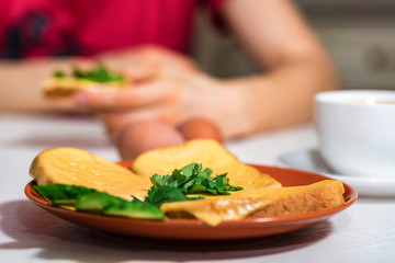 Breakfast of cheese sandwich, eggs and coffee