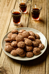 amaretti cookies with liqueur beside - traditional Italian pastry products