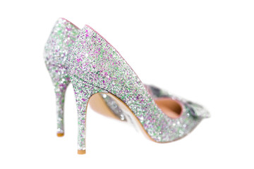 Beautiful silver glitter high heel female shoes isolated on white. Wedding accessories . Cinderella...