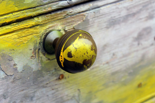 Round Brass Handle Knob On A Wooden Door