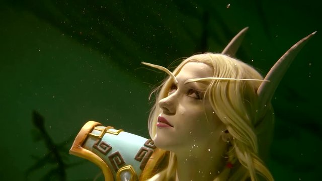 Close up shot of a lovely blone elf lonely floating under water on its back. Beautiful blonde hairs take a fantastic forms.
