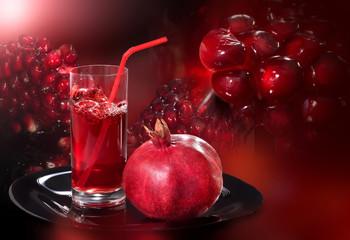 Garnet and juice on a tray of a red background. Seeds, pomegranate seeds close up.