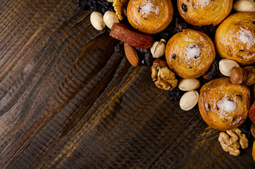 nuts, dried fruits, pistachios and homemade cookies scattered from the bag on the table with a place for writing