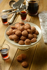 amaretti cookies with liqueur beside - traditional Italian pastry products
